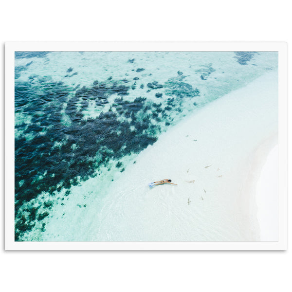 an aerial view of a beach with a boat in the water