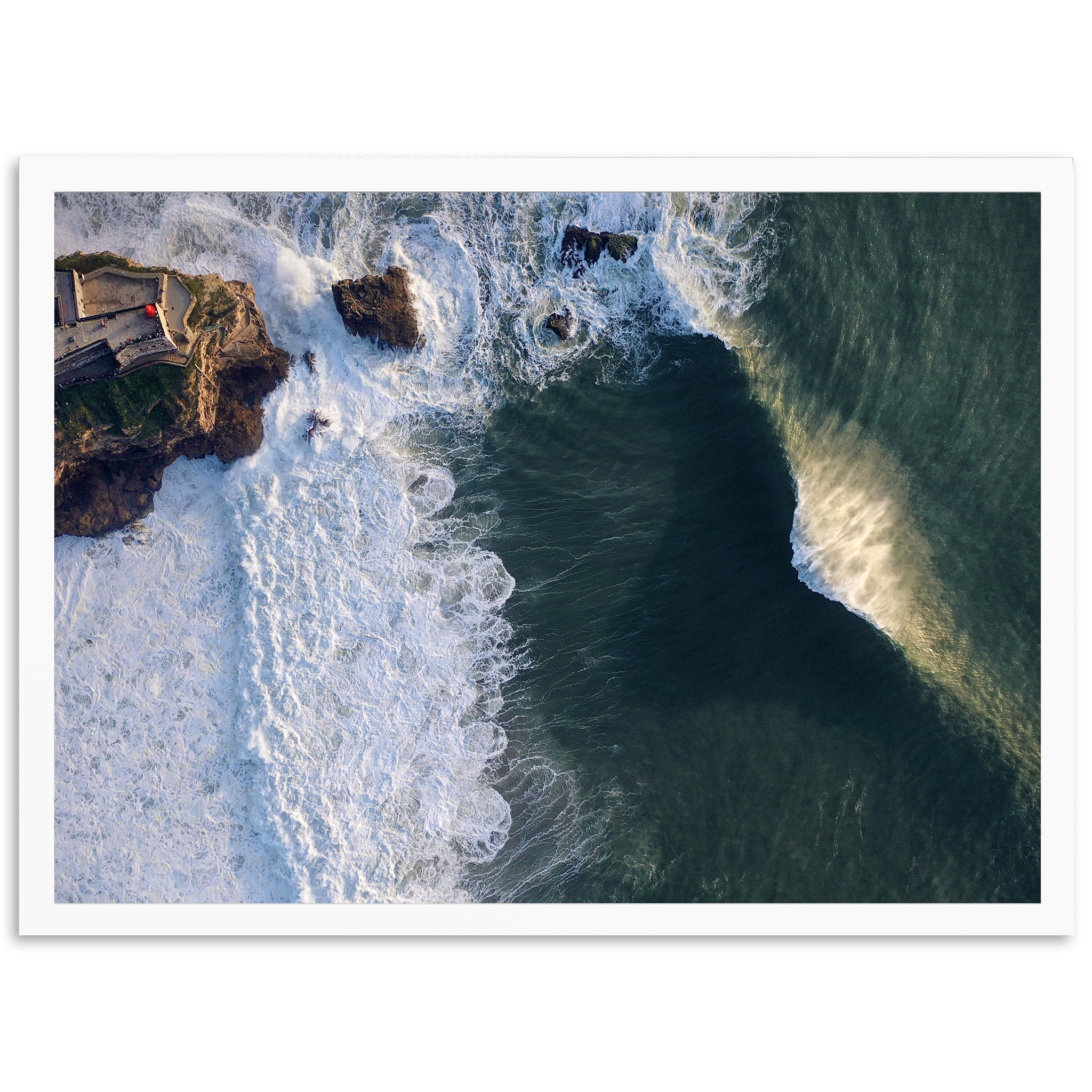 an aerial view of the ocean with waves