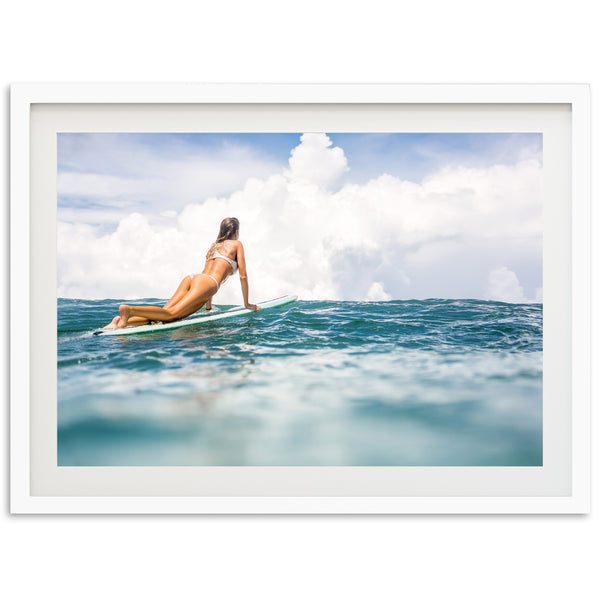 a woman riding a surfboard on top of a wave