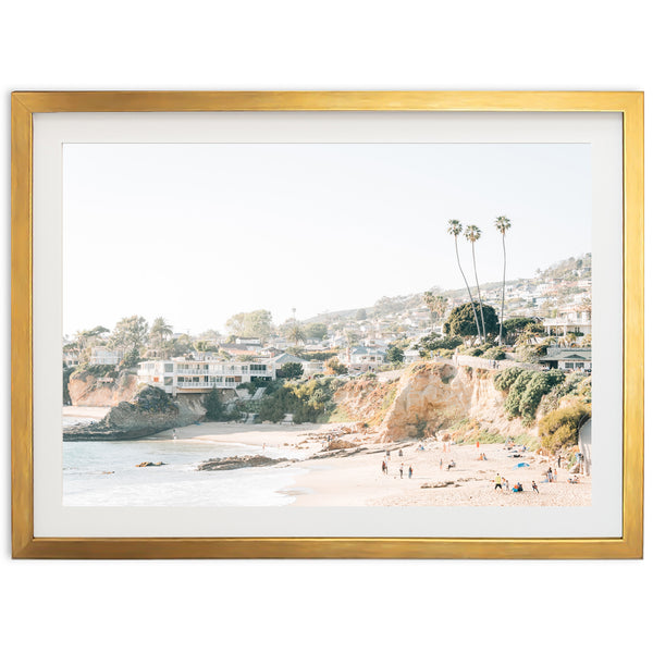 a framed photograph of a beach with palm trees