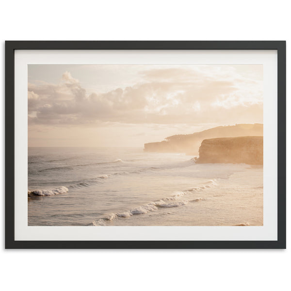 a picture of a beach with a cliff in the background