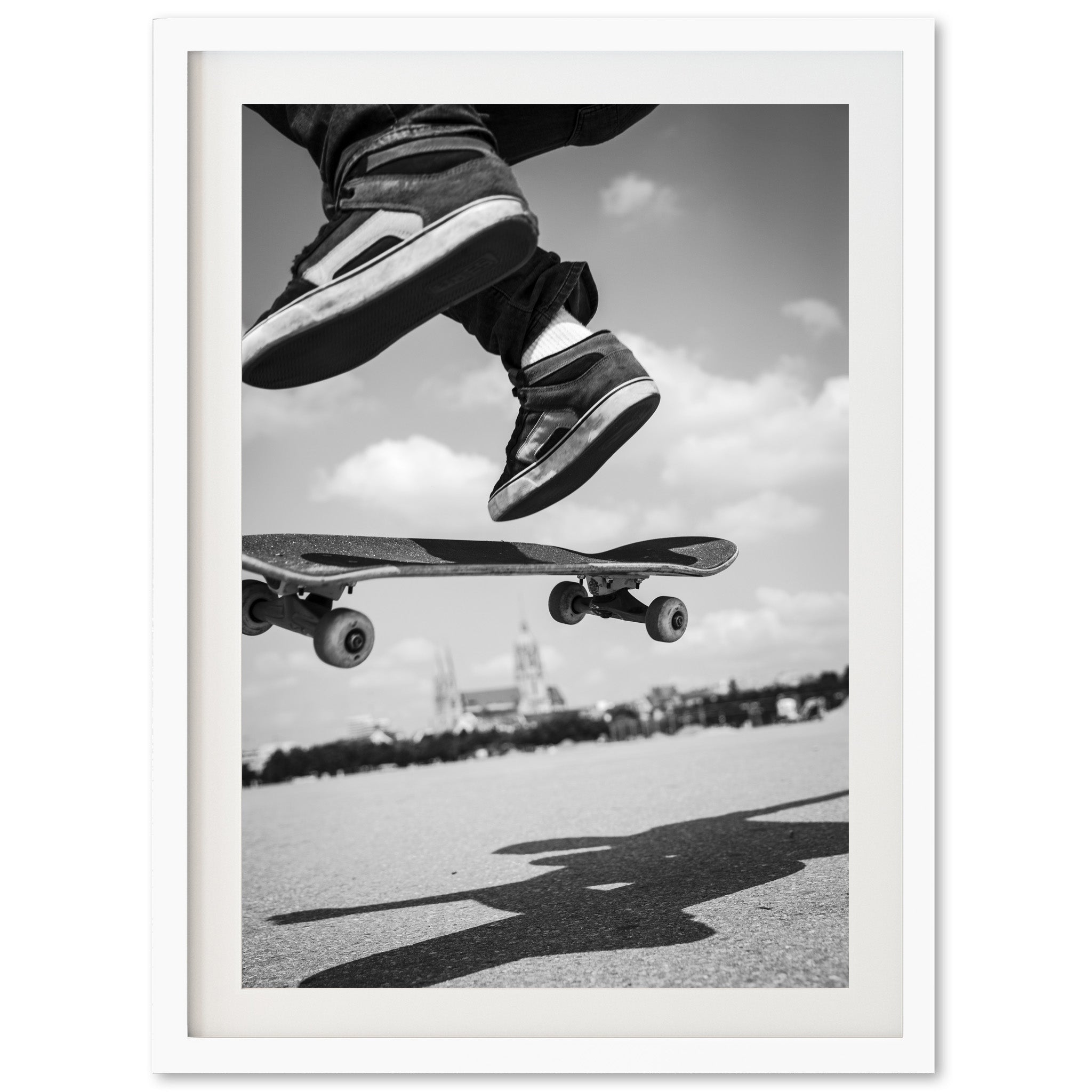 a black and white photo of a person jumping a skateboard