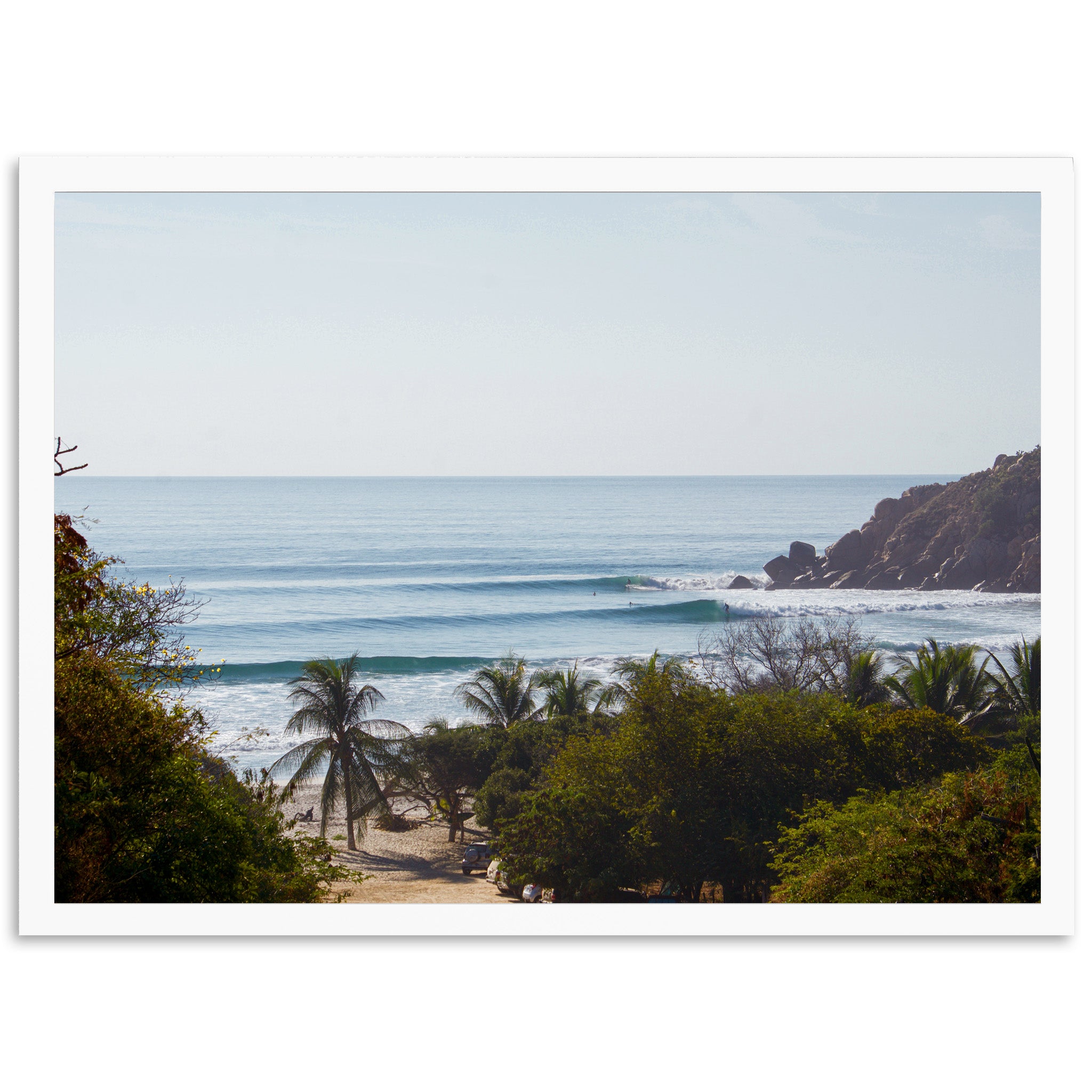 a picture of a beach with a wave coming in