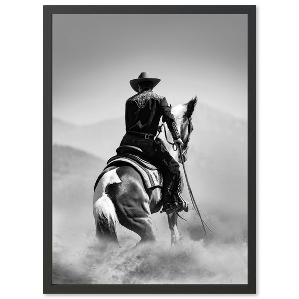 a black and white photo of a cowboy on a horse