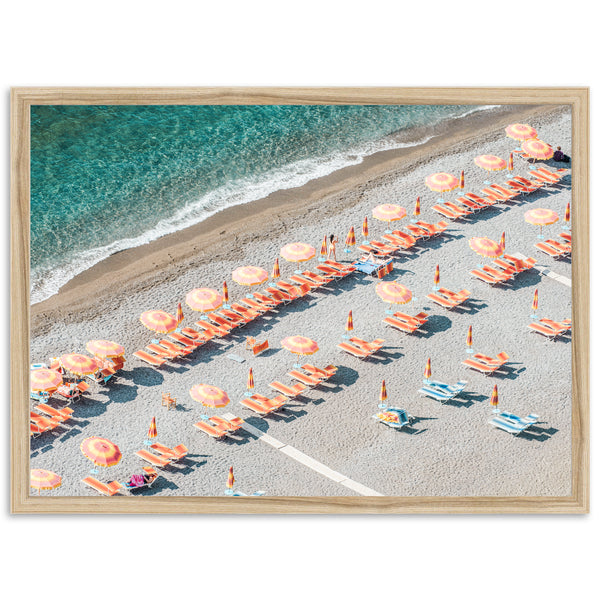 an aerial view of a beach with umbrellas and chairs