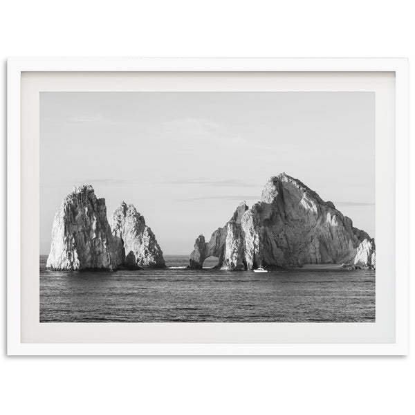 a black and white photo of rocks in the ocean