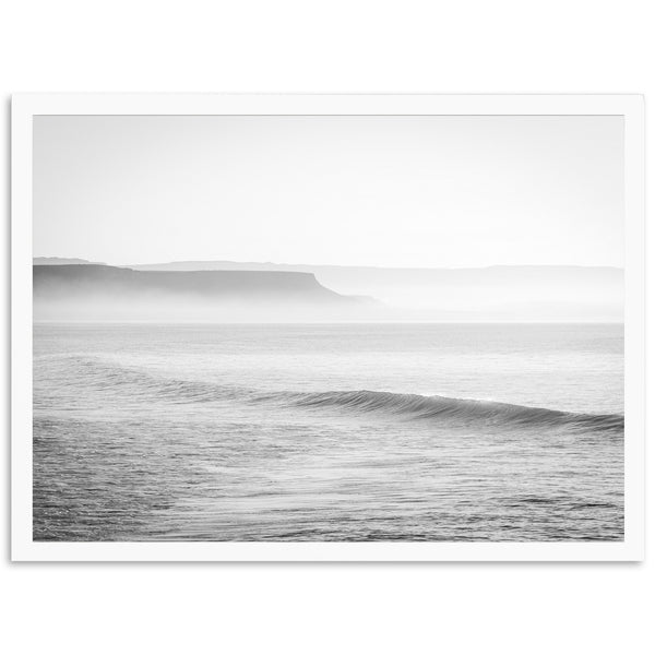 a black and white photo of a wave in the ocean