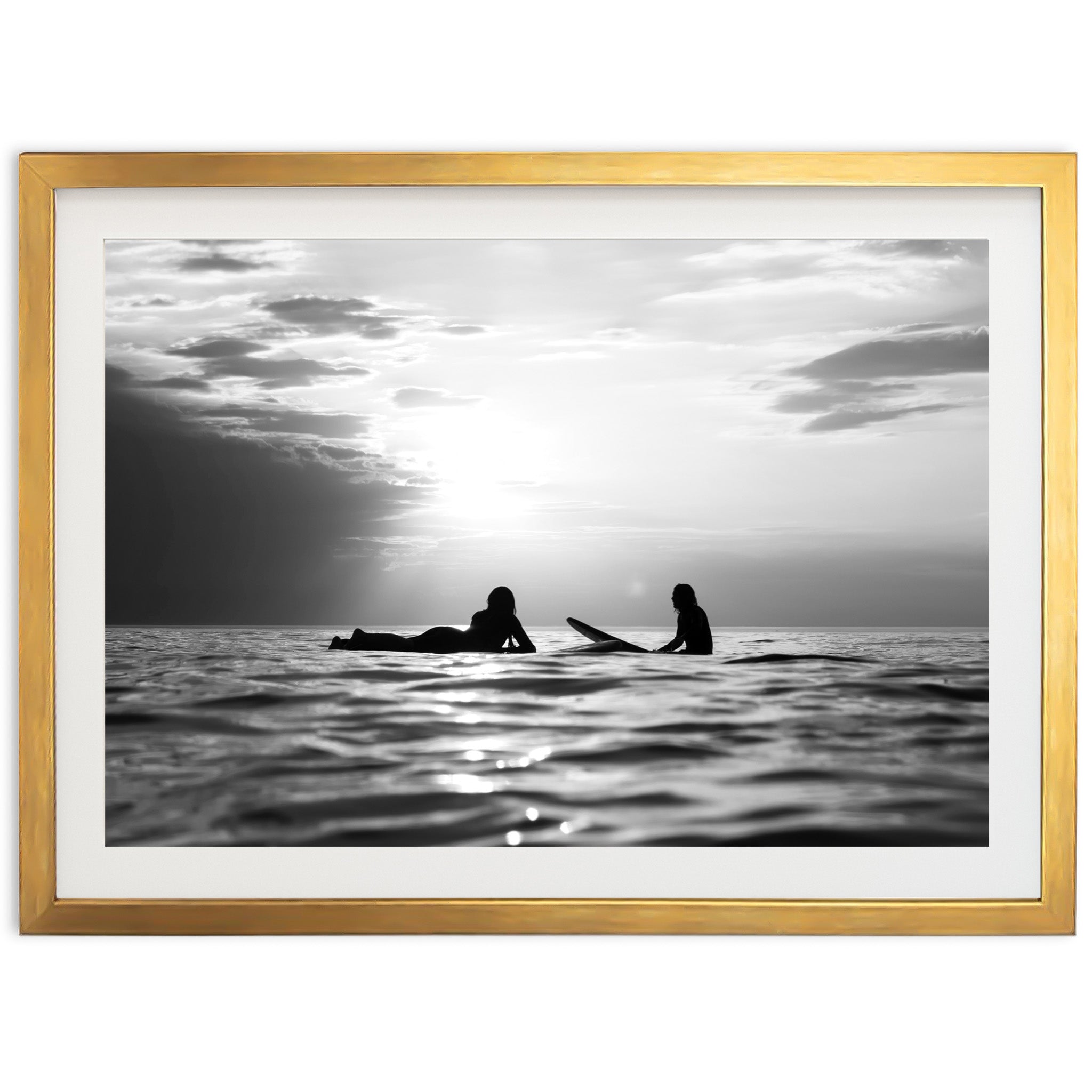 a black and white photo of two people on surfboards