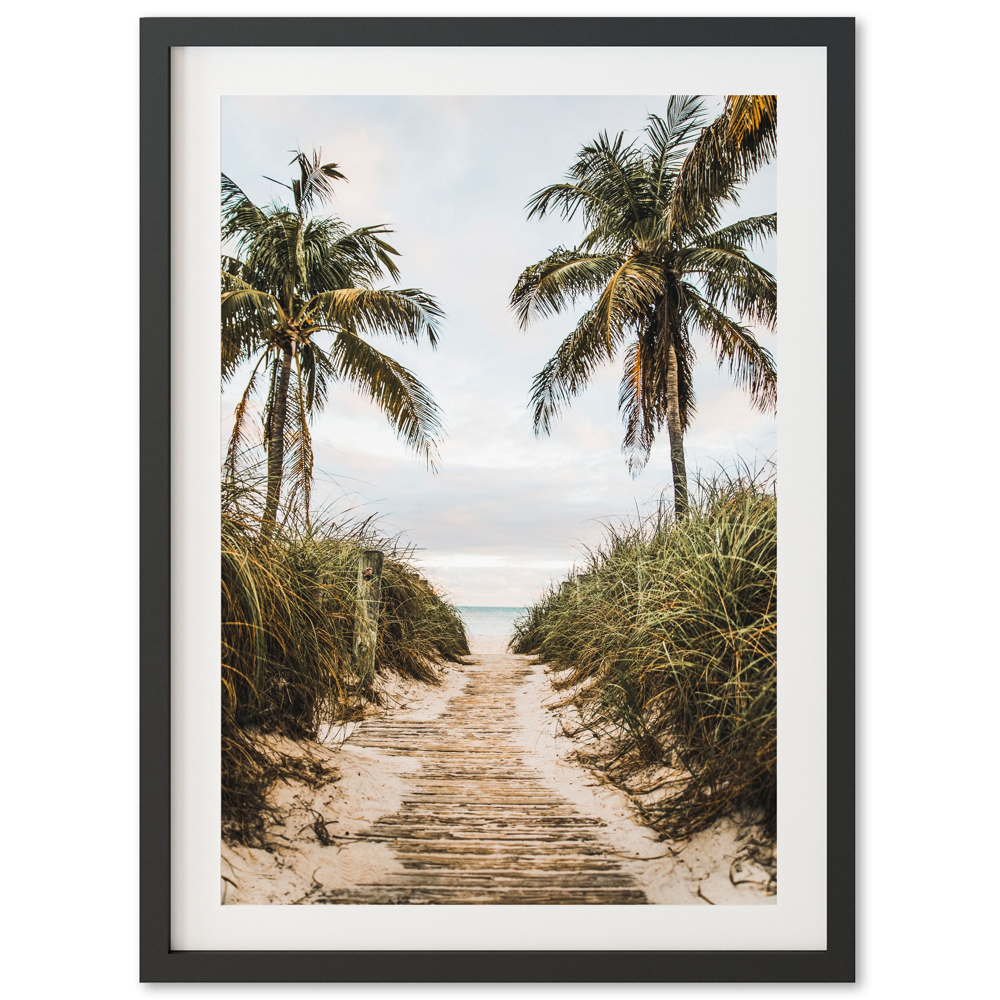 a framed photograph of a path leading to the beach