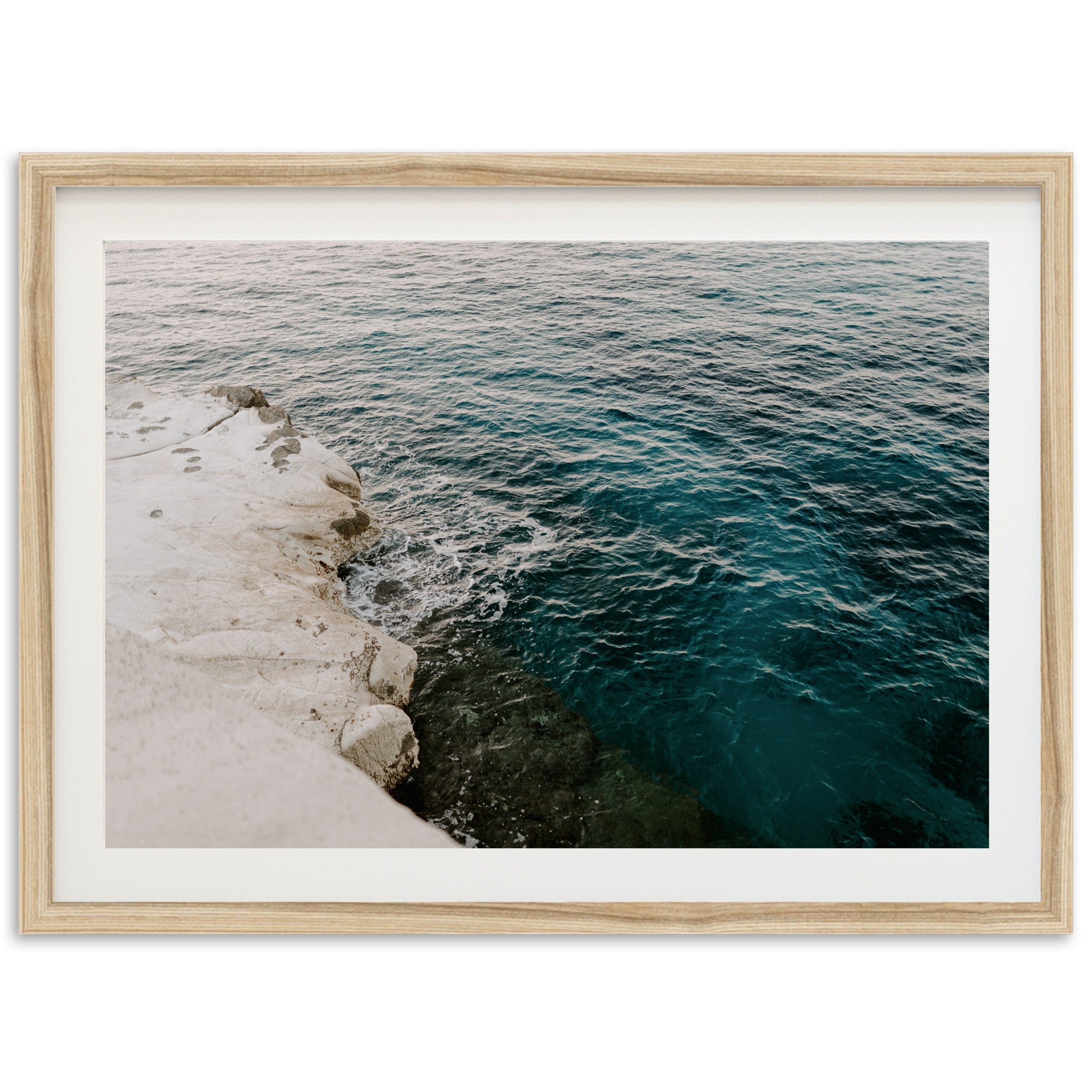 a picture of a body of water with rocks in the foreground