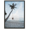 a woman sitting on a swing between two palm trees