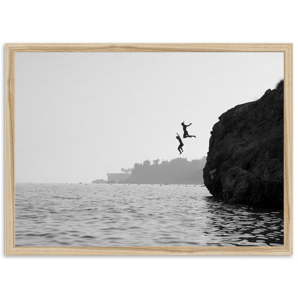 a person jumping off a cliff into the water