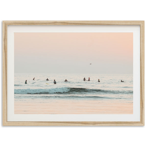 a group of people riding surfboards on top of a wave