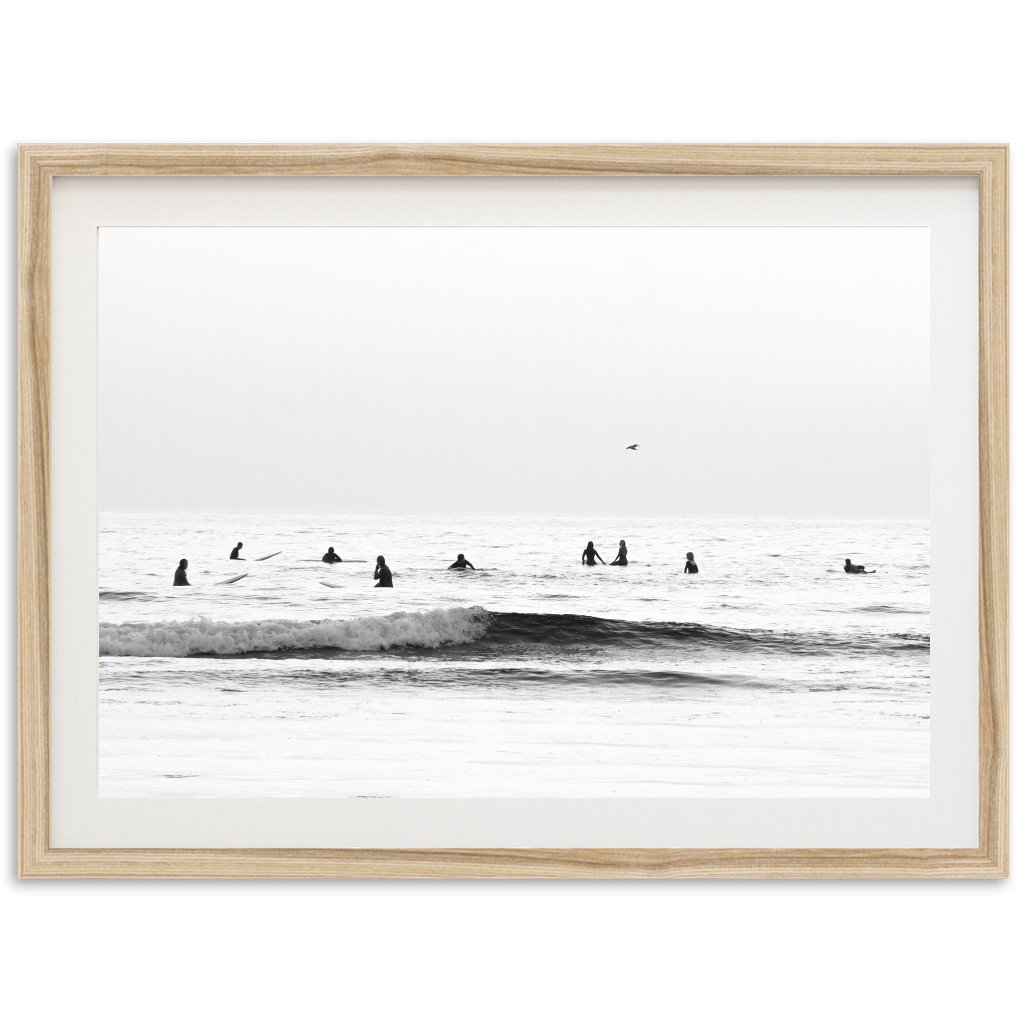 a black and white photo of surfers in the ocean