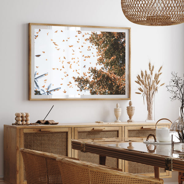 a dining room with a table, chairs and a picture hanging on the wall