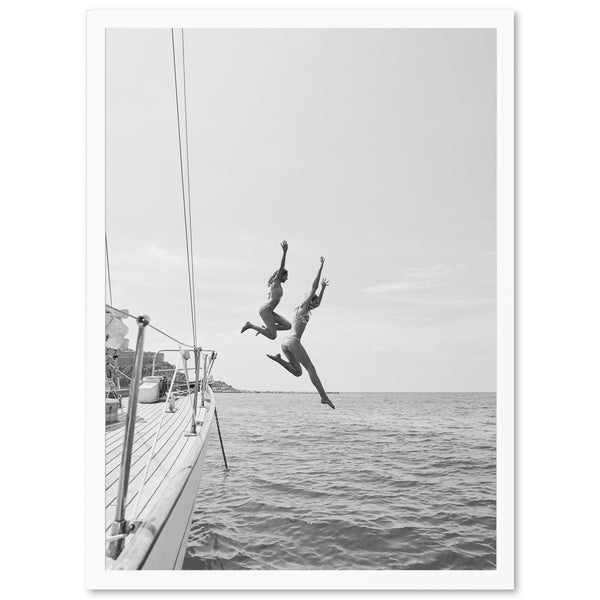 two people jumping off a boat into the water