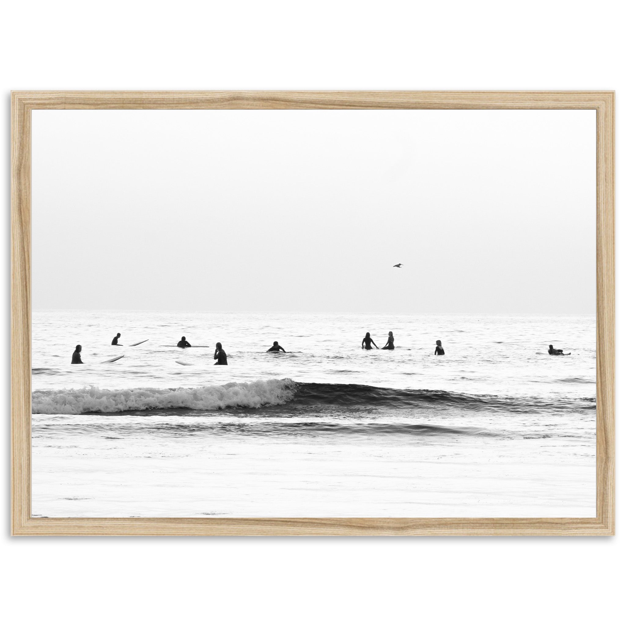 a black and white photo of surfers in the ocean