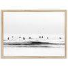 a black and white photo of surfers in the ocean