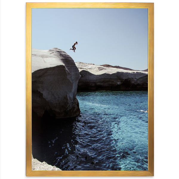 a person jumping off a cliff into a body of water