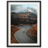 a man riding a skateboard down a curvy road