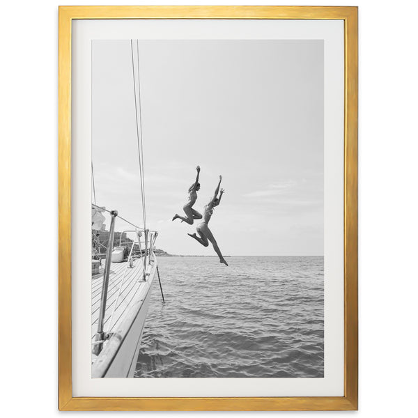 a black and white photo of a person jumping off a boat