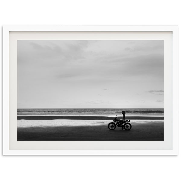 a black and white photo of a person on a motorcycle