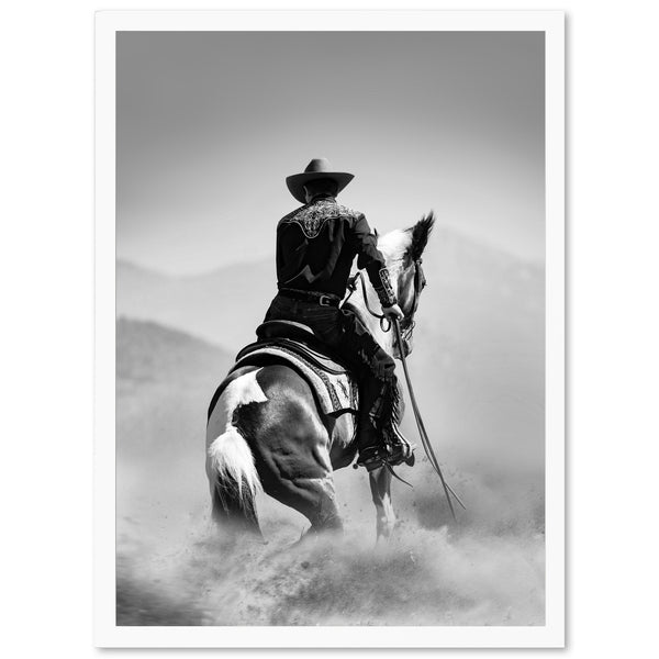 a black and white photo of a cowboy on a horse