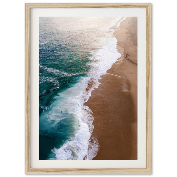 an aerial view of a beach with waves coming in