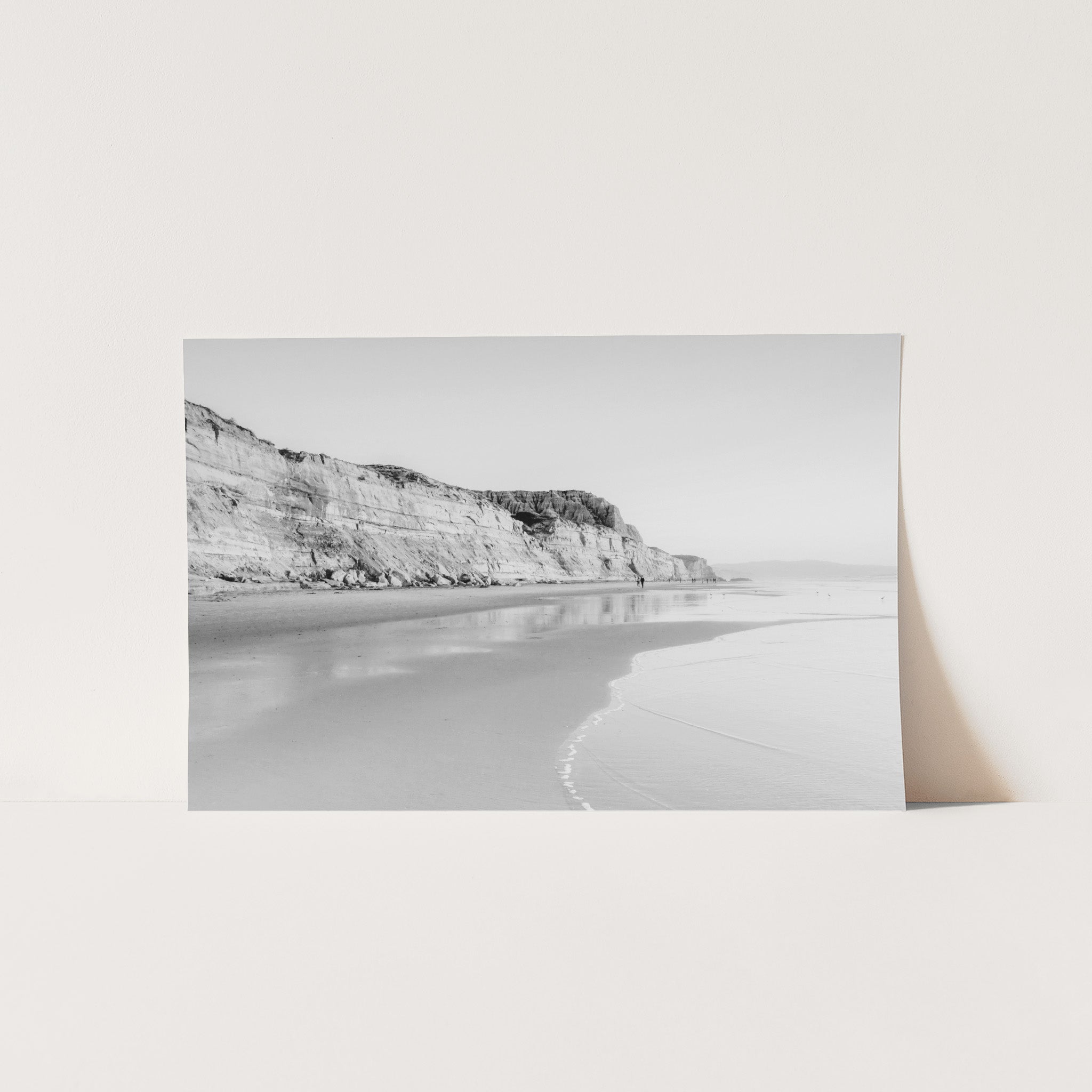 a black and white photo of a beach