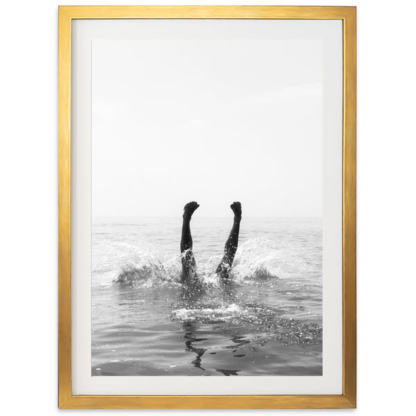 a black and white photo of two people in the water