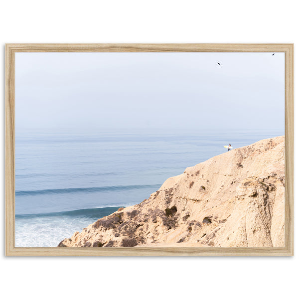 a person standing on a cliff overlooking the ocean