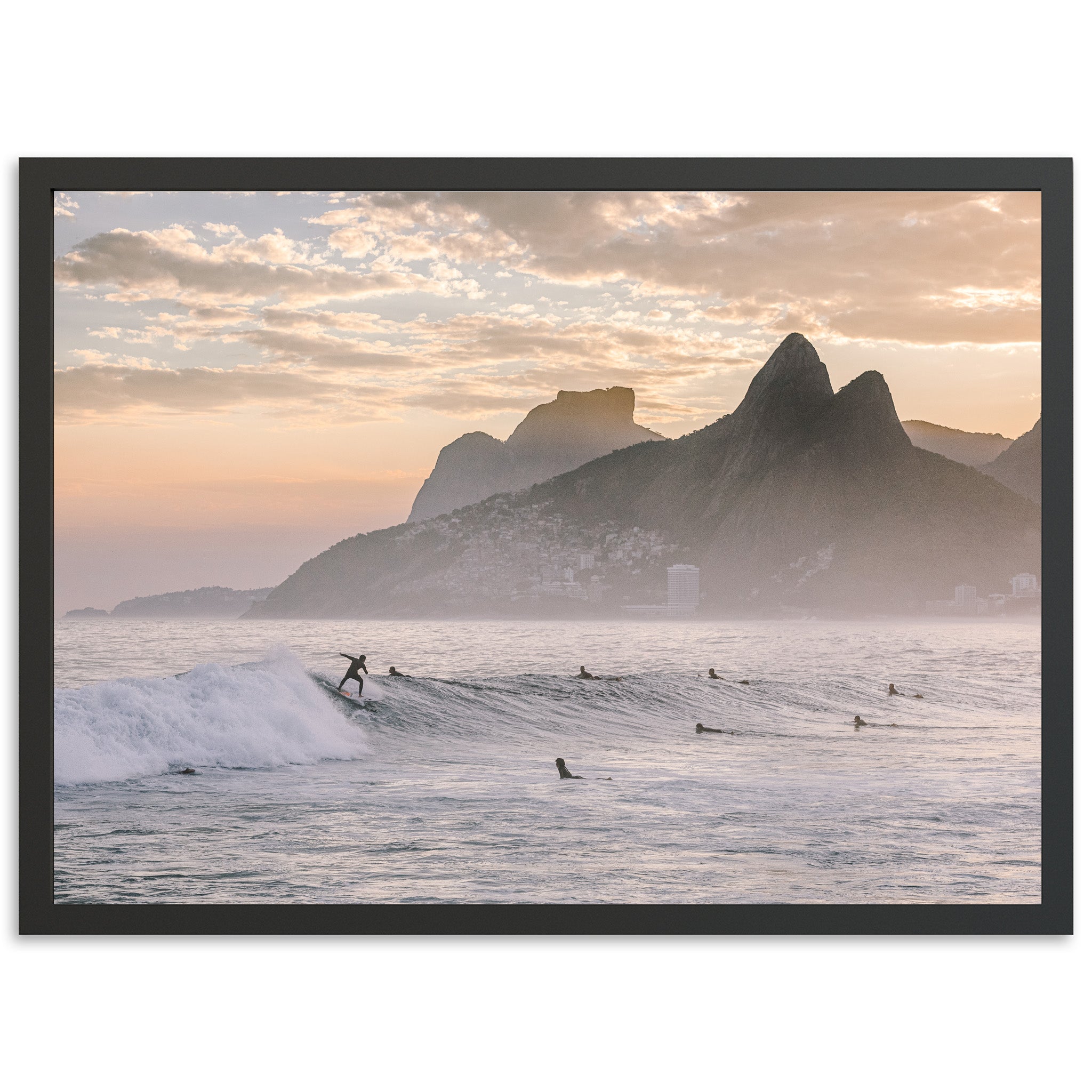 a surfer riding a wave in the ocean with mountains in the background