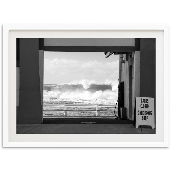 a black and white photo of a wave coming in from the ocean