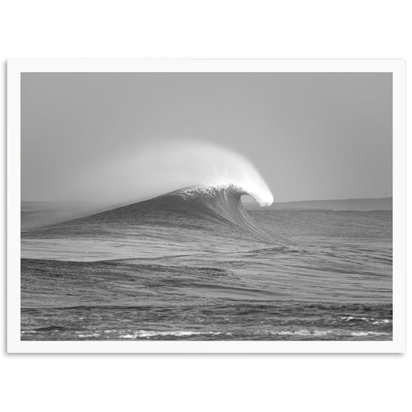 a black and white photo of a wave in the ocean