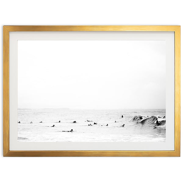 a black and white photo of surfers in the ocean