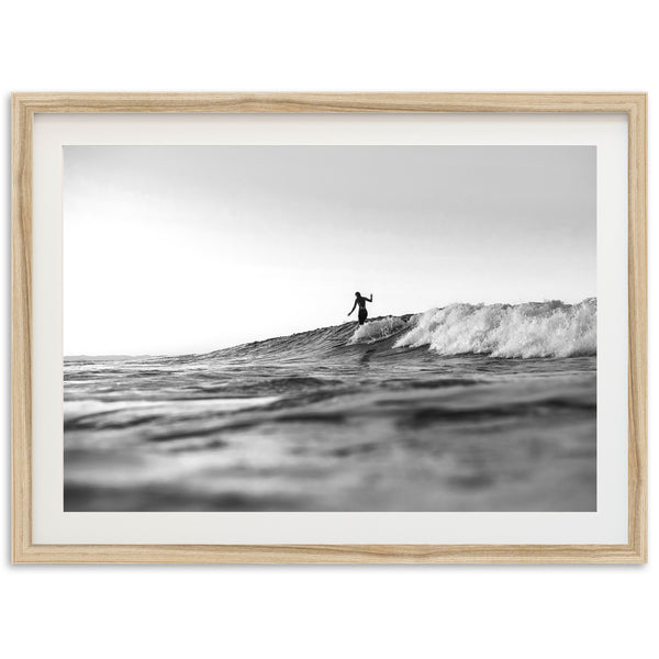 a black and white photo of a surfer on a wave