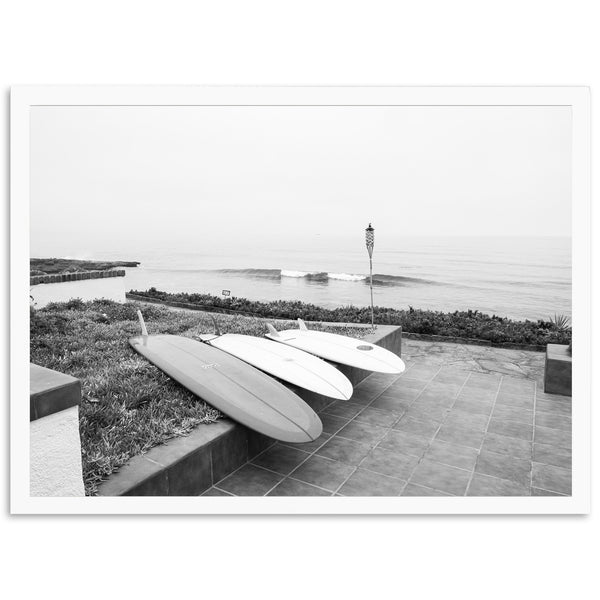 a couple of surfboards sitting on top of a sidewalk