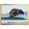 a large rock sticking out of the ocean