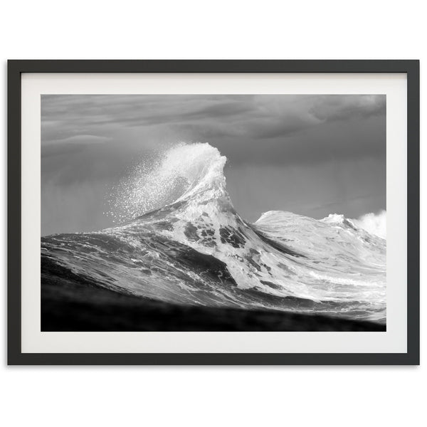 a black and white photo of a wave in the ocean