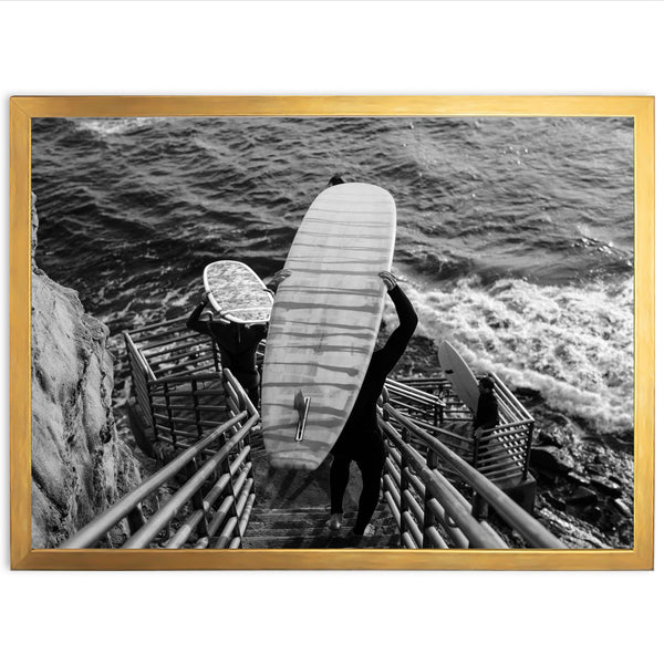 a black and white photo of a person holding a surfboard