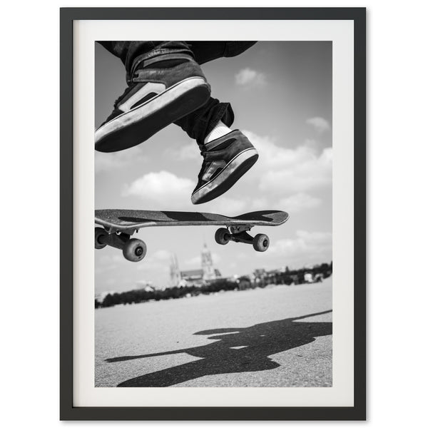 a black and white photo of a skateboarder doing a trick