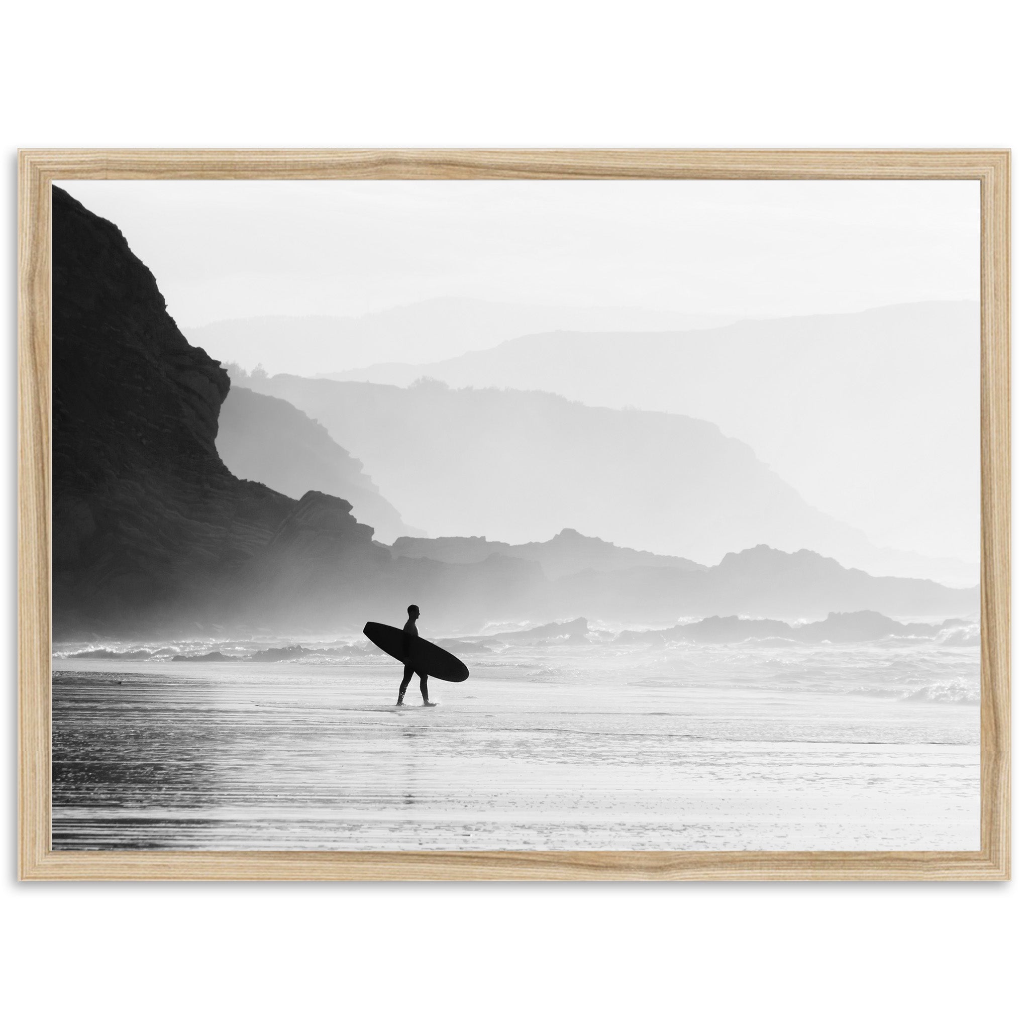 a black and white photo of a person carrying a surfboard