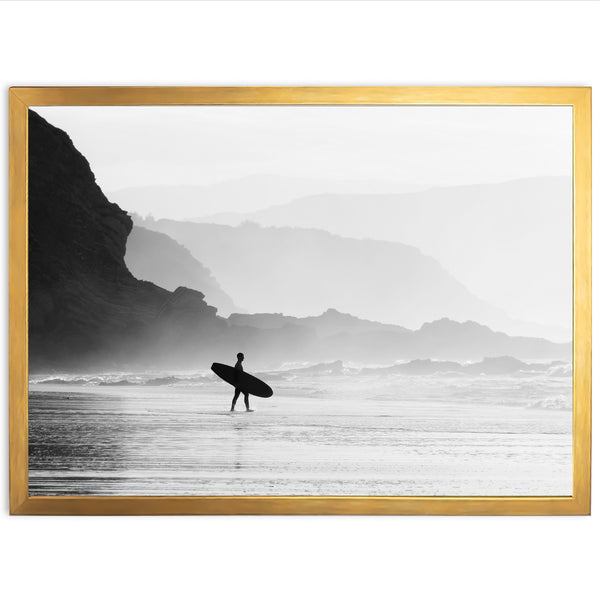 a black and white photo of a person holding a surfboard