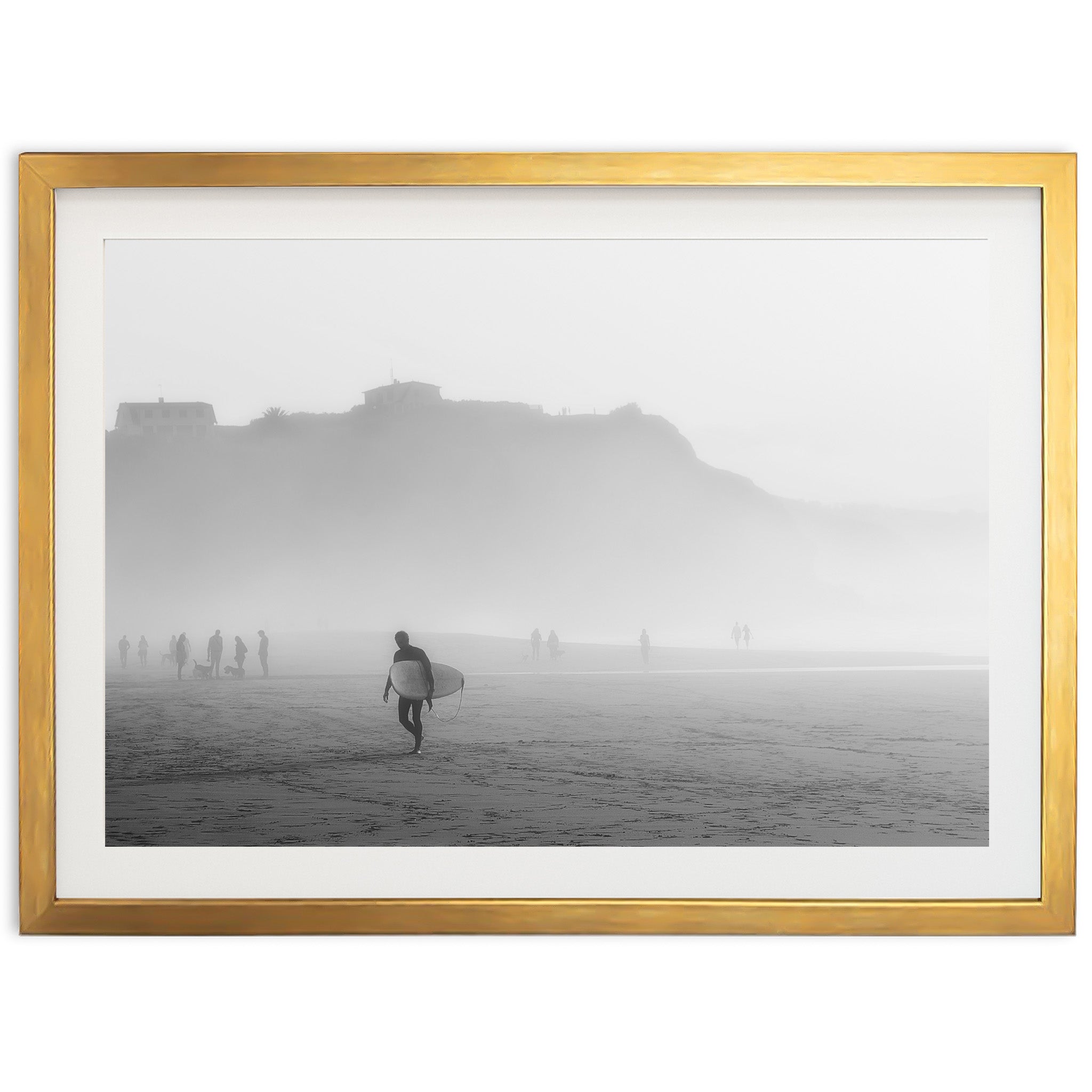 a black and white photo of a person carrying a surfboard