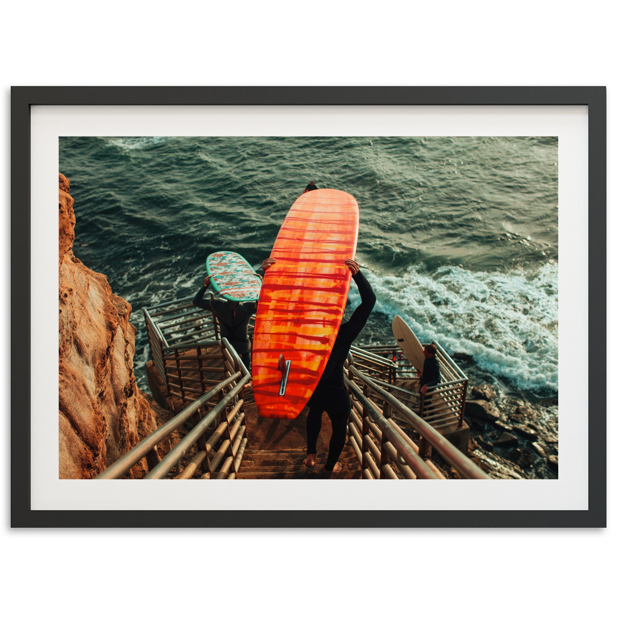 a man holding a surfboard on top of a stairway