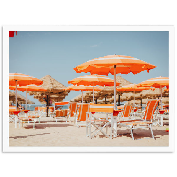 a bunch of chairs and umbrellas on a beach