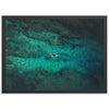 an aerial view of a person riding a surfboard in the ocean