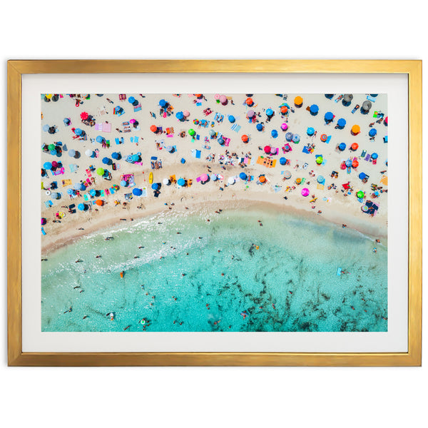 an aerial view of a beach with umbrellas