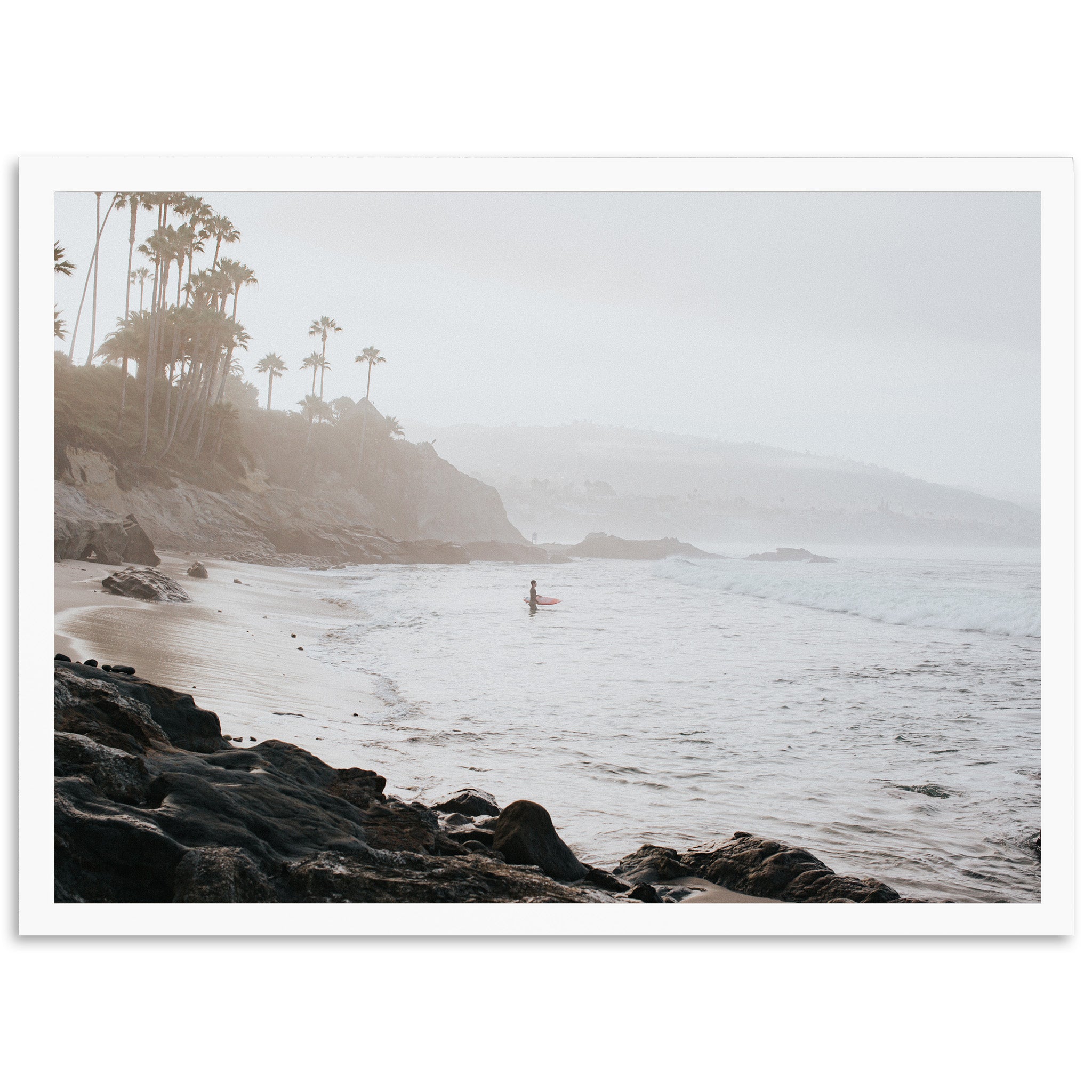 a person standing on a surfboard in the ocean