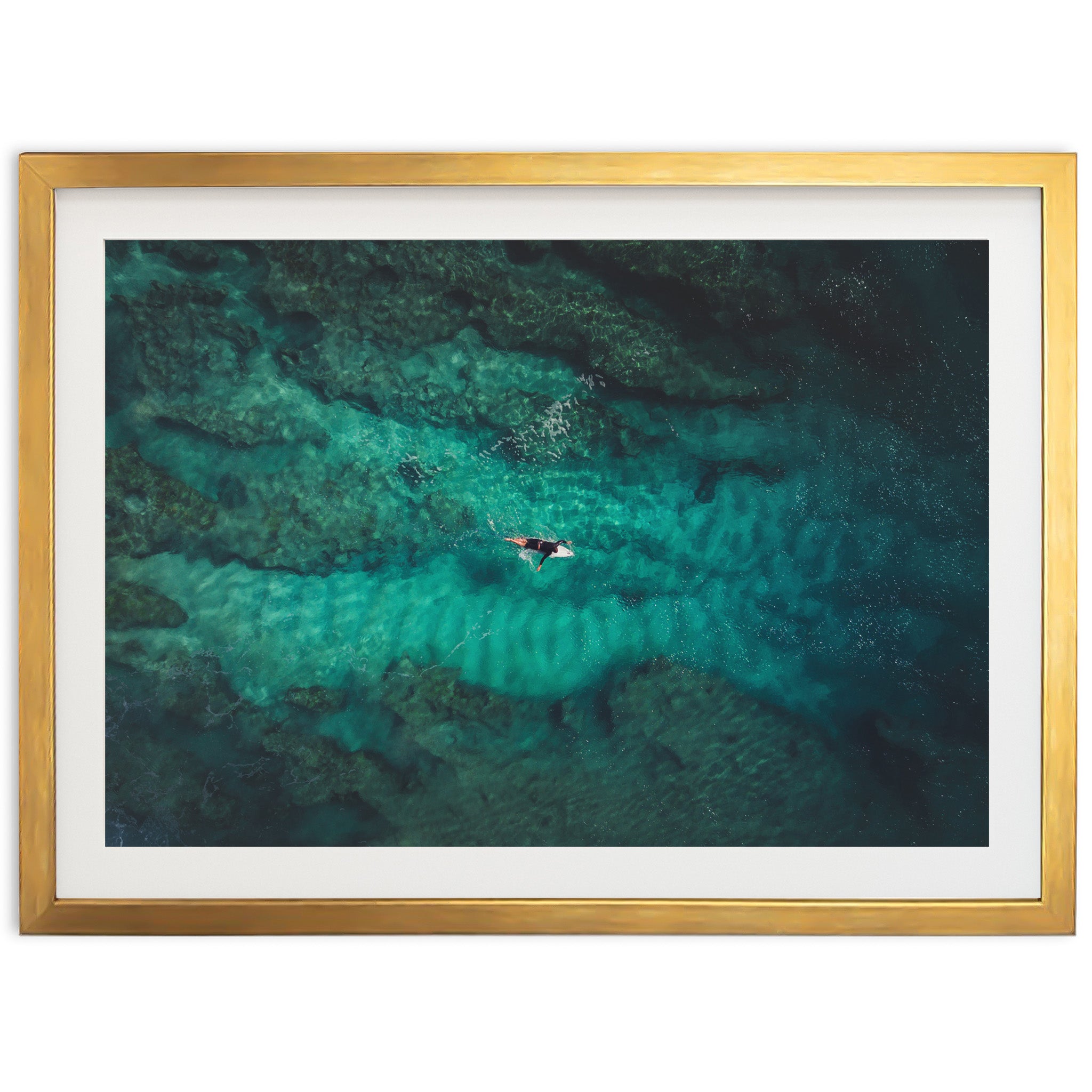 an aerial view of two people swimming in the ocean